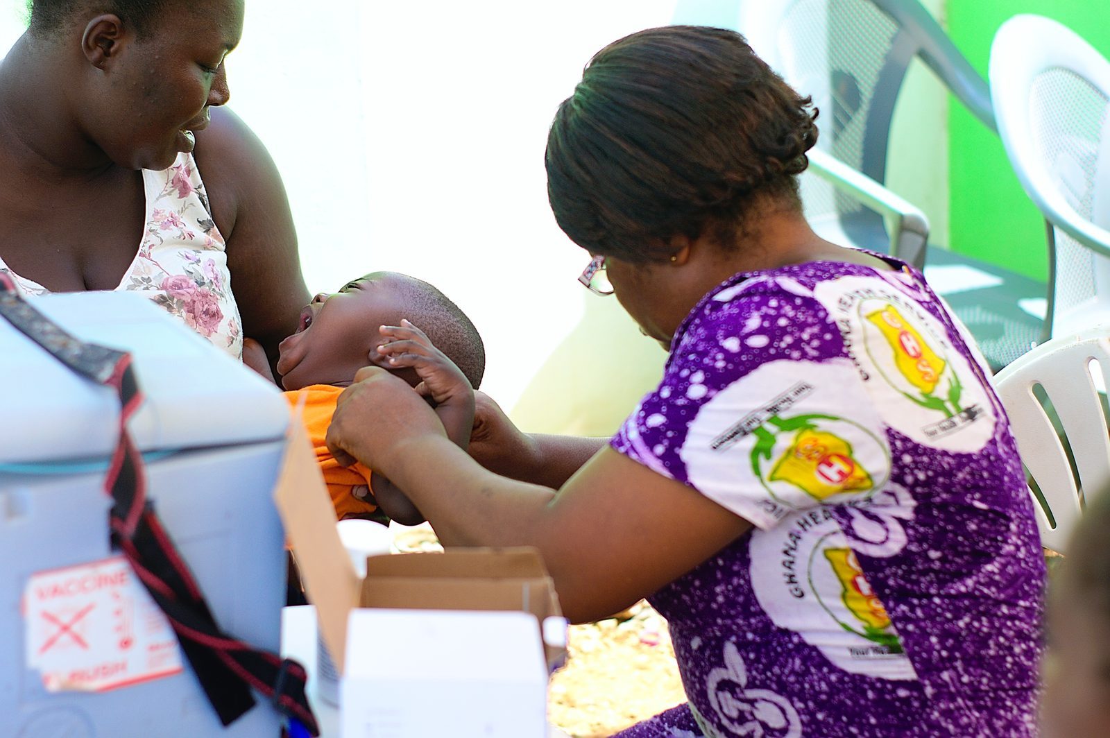 A child receiving a vaccination injection from a healthcare worker