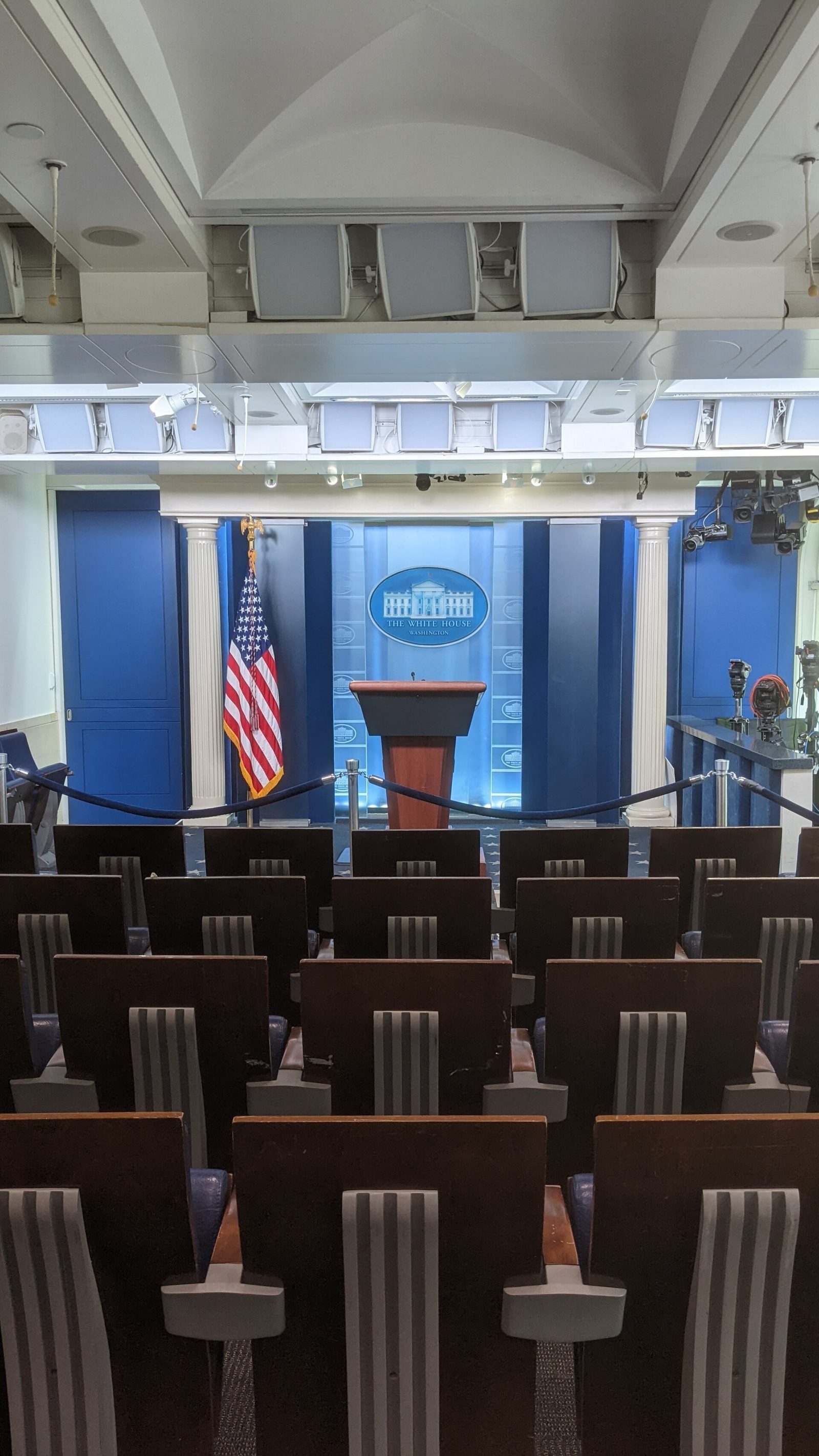 Empty James S. Brady Press Briefing Room in the White House West Wing, with podium and press seating