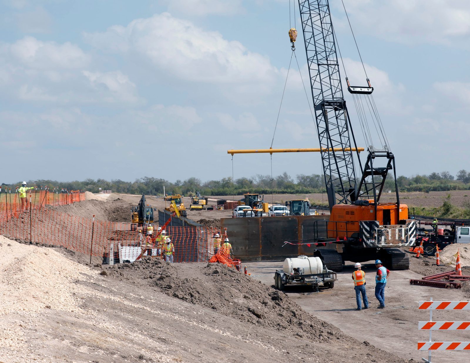 CBP construction workers erecting steel border wall panels near Weslaco, Texas, October 2019