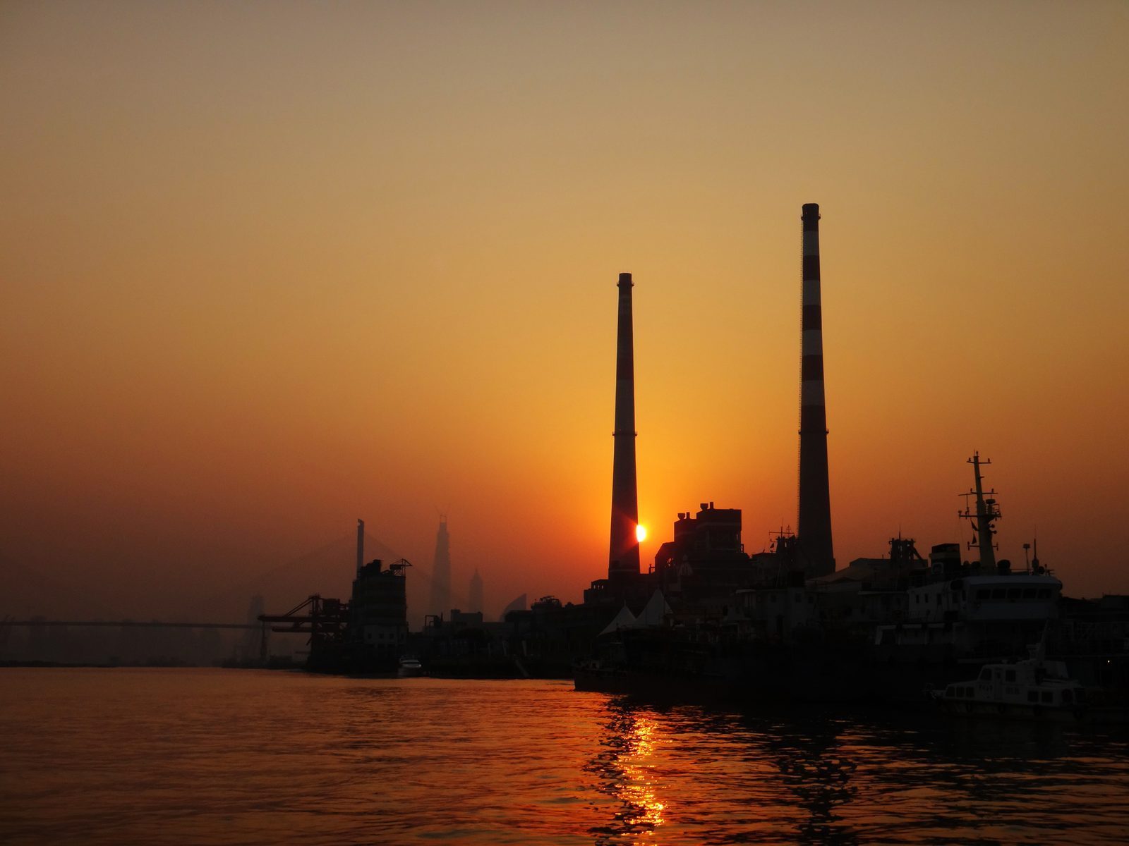 Yangshupu Power Plant with smokestacks at sunset along the Huangpu River, Shanghai