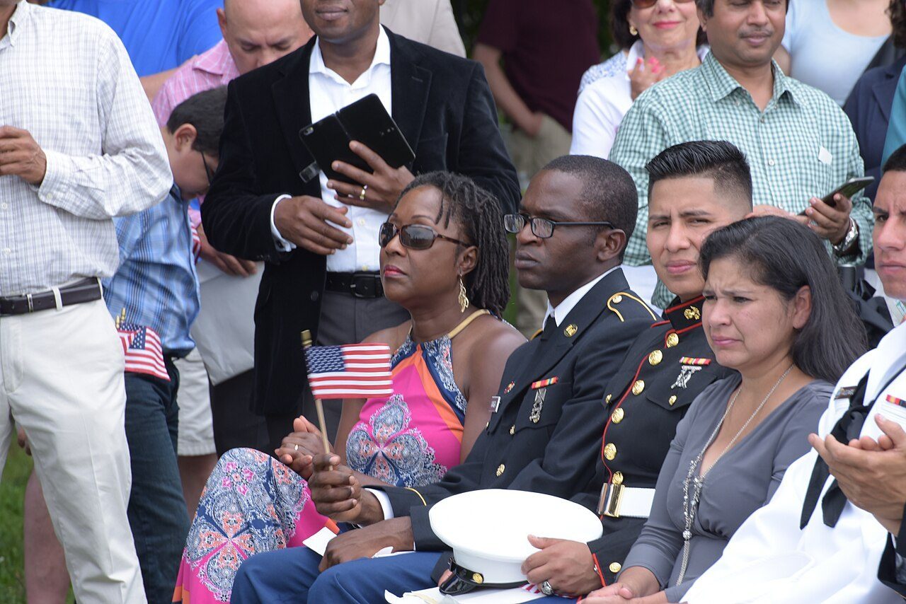 U.S. Citizenship and Immigration Services official administers the Oath of Allegiance at a naturalization ceremony.