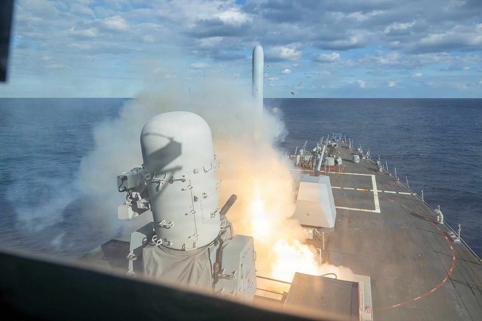 The U.S. Navy destroyer USS Bulkeley fires a Tomahawk land-attack missile from its deck at sea.