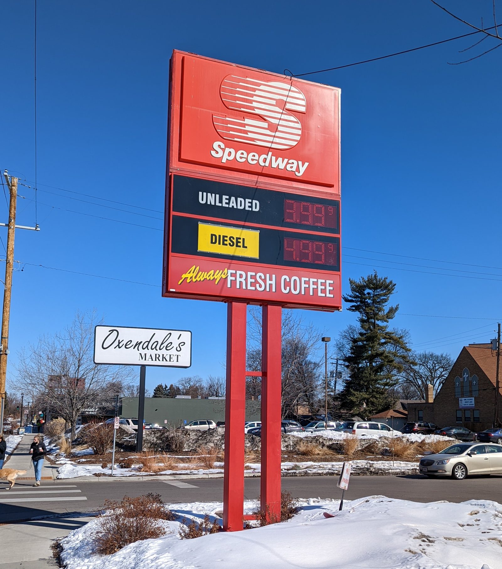 A gas station price sign displaying high unleaded and diesel fuel prices