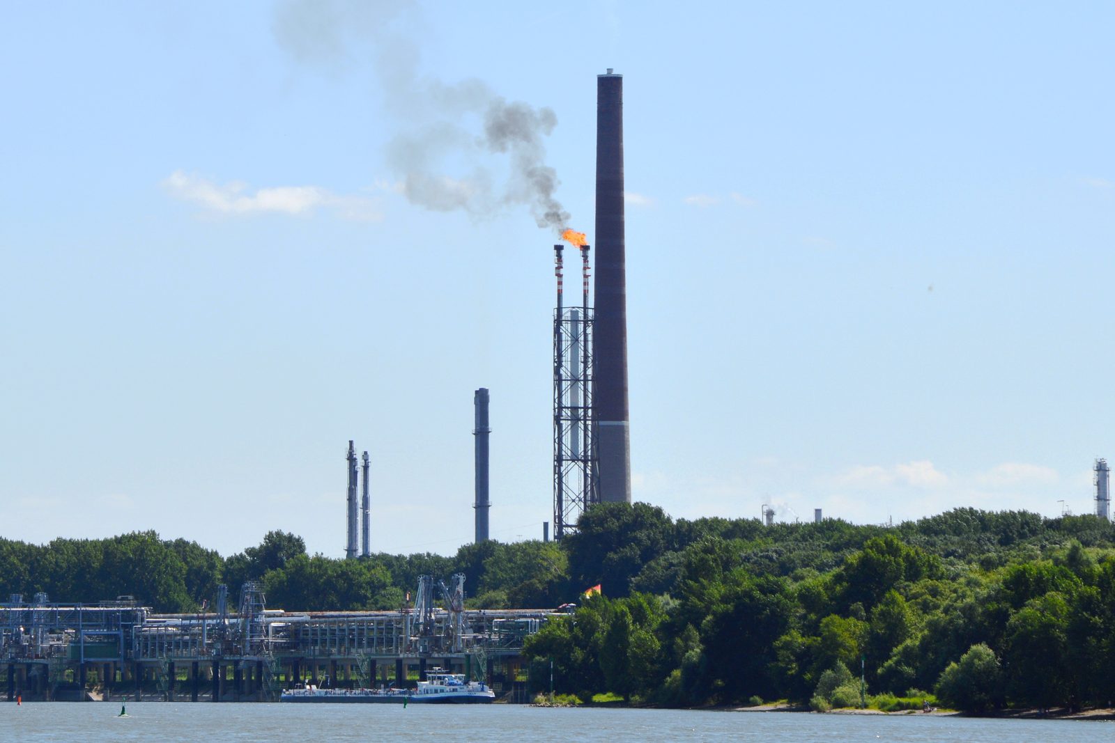 Gas flare burning off methane at the Rheinland Raffinerie chemical plant, Wesseling, Germany