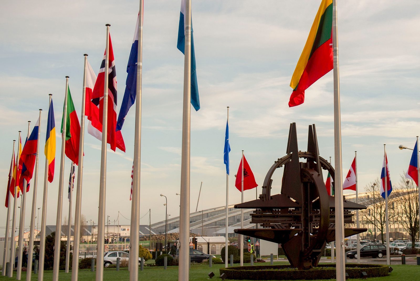 NATO member country flags flying at the entrance of NATO headquarters in Brussels, Belgium