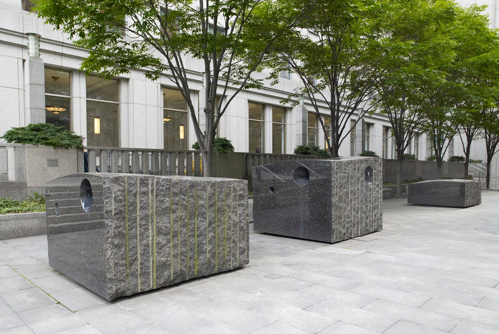 Granite "Sounding Stones" sculptures on the plaza outside the Daniel Patrick Moynihan U.S. Courthouse in Manhattan, with the courthouse facade behind.