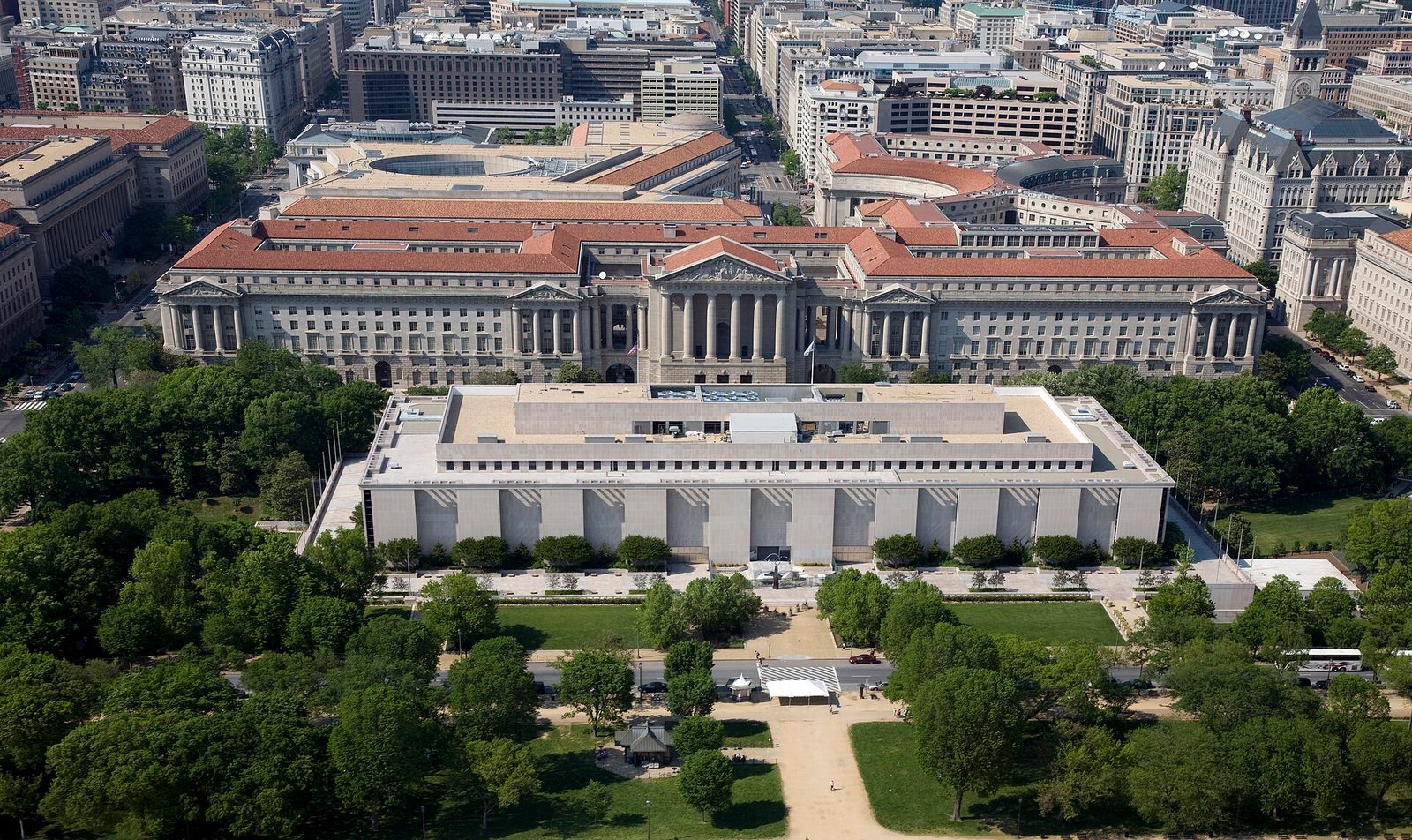Aerial view of the Smithsonian's National Museum of American History on the National Mall, with Federal Triangle buildings behind it.