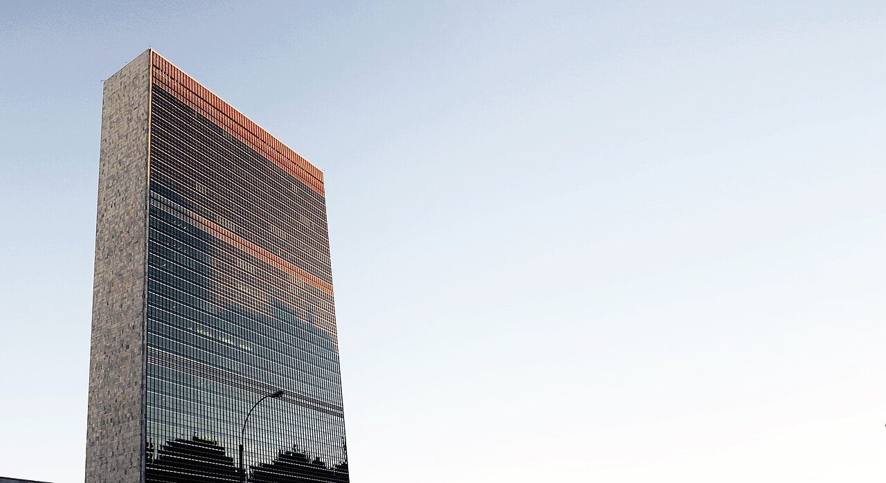 The United Nations Headquarters Secretariat building in New York at sunset.