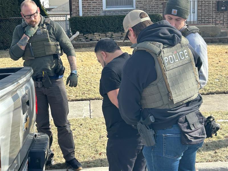 ICE and DHS agents detaining a man during a January 2025 enforcement operation